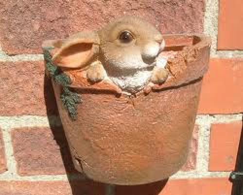 A decorative wall hanging plant pot with a 3D Rabbit sitting