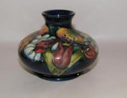 Antiques; A small bulbous Moorcroft orchid pattern vase. English c.1950.